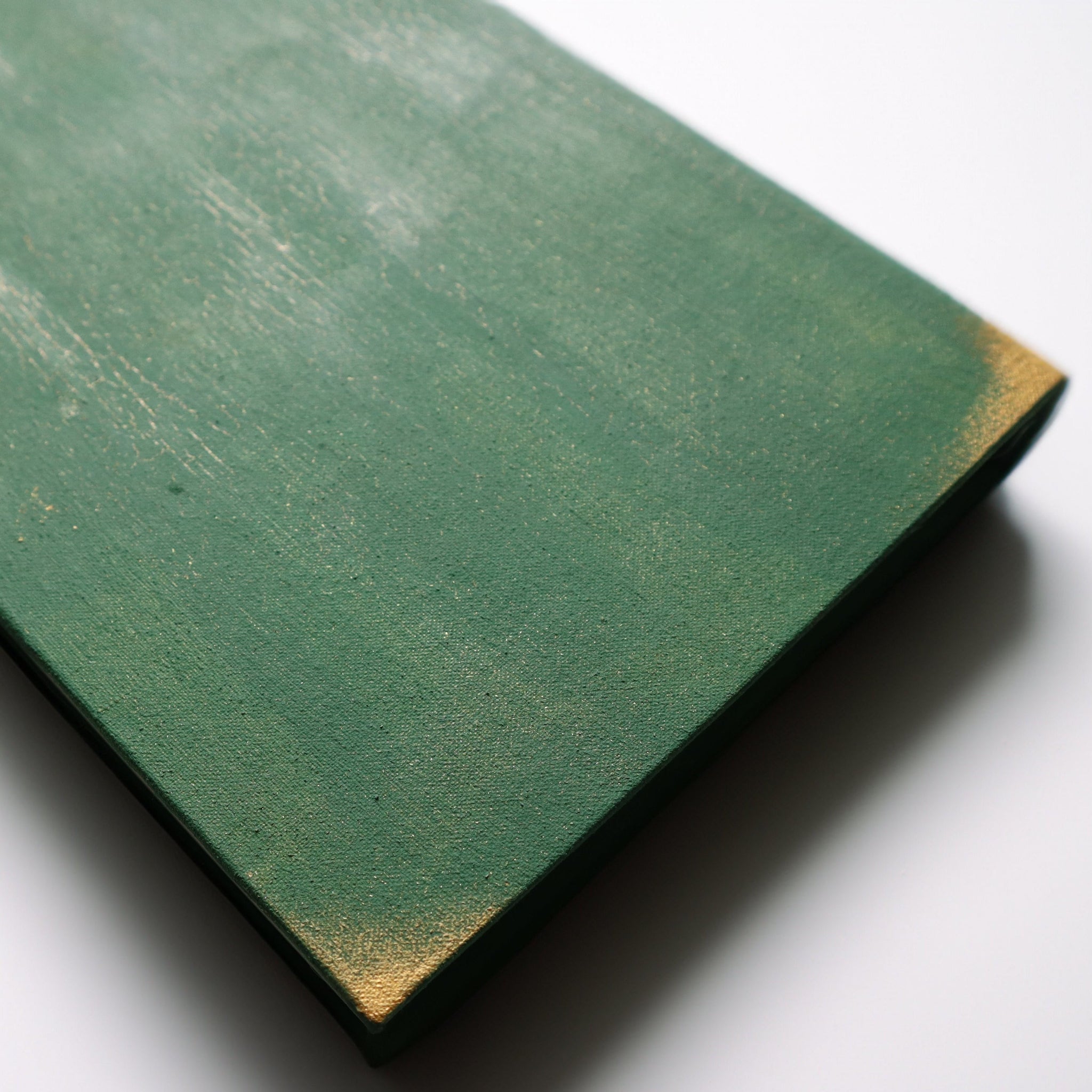 The back of a green journal with gold crackle and gold corners.